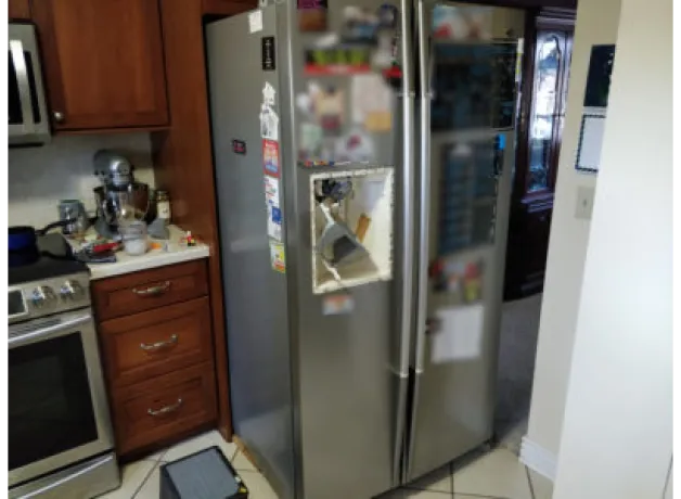 LG side-by-side refrigerator with the dispenser disassembled